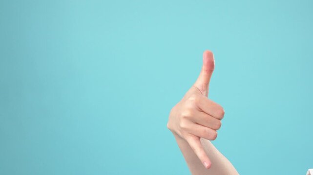 Hand gestures showing point and call me sign on blue background