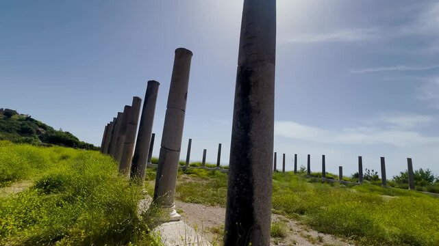 Ancient Roman stone columns ruins of Antiochia ad Cragum archaeological site in Turkey against blue sky