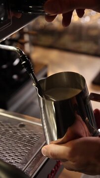 A professional bartender prepares fresh coffee in a stylish caf&eacute; atmosphere. Close-up details, steam, coffee aroma, and cinematic lighting create a cozy premium hospitality scene perfect for caf&eacute;s, re