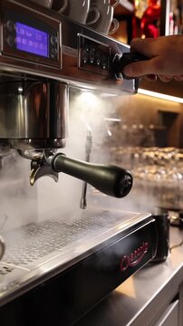 A professional bartender prepares fresh coffee in a stylish caf&eacute; atmosphere. Close-up details, steam, coffee aroma, and cinematic lighting create a cozy premium hospitality scene perfect for caf&eacute;s, re