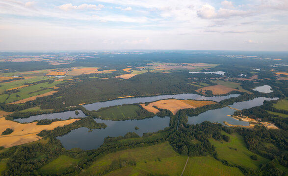 Aerial panorama of Vlkov sand pits near Trebon, South Bohemia, Czech Republic, captured on a warm summer afternoon with lakes, forests and agricultural landscape.

