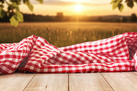 Checkered Picnic Fabric on Sunset Display Wood Table bokeh nature background 4k