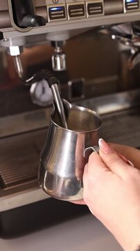A professional bartender prepares fresh coffee in a stylish caf&eacute; atmosphere. Close-up details, steam, coffee aroma, and cinematic lighting create a cozy premium hospitality scene perfect for caf&eacute;s, re
