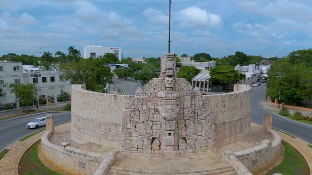 A high-angle aerial landscape shot captures the magnificent Monumento a la Patria, located in a prominent traffic roundabout along the iconic Paseo de Montejo avenue in M&eacute;rida, Mexico.