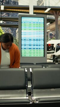 Busy bus station with travelers waiting for express and sleeper bus routes. Multicultural passengers with baggage sitting in waiting area before long-distance interstate journey.