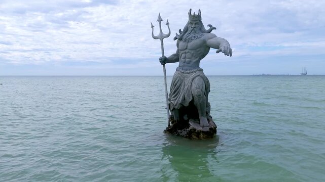 Greek God Poseidon Statue inside the Ocean at Progreso Beach Yucatan. Mexico.