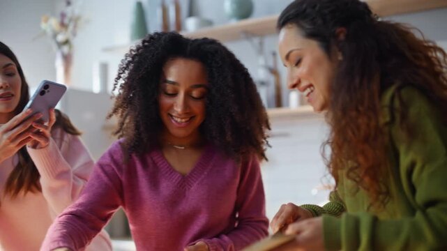 Smiling bloggers preparing salad in kitchen closeup. Happy women recording blog