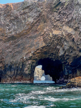 Natural rock arch in the ocean near Ballestas Islands, Peru