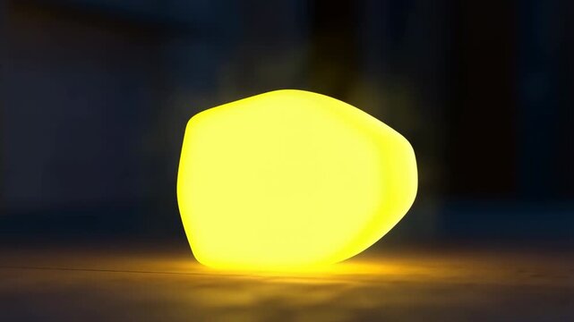 Glowing cube lamp changing color from yellow to blue in a dark room