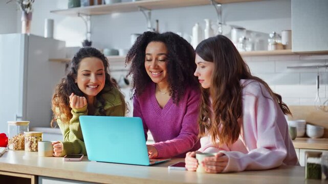 Happy friends looking computer at kitchen closeup. Bestie supporting woman