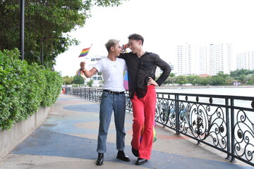 Fototapeta premium Pride month. Friends from IGBTQ, men, women, lesbians, and transgender people of various nationalities joined the parade, carrying signs and flags celebrating equal rights at Pride Festival. 