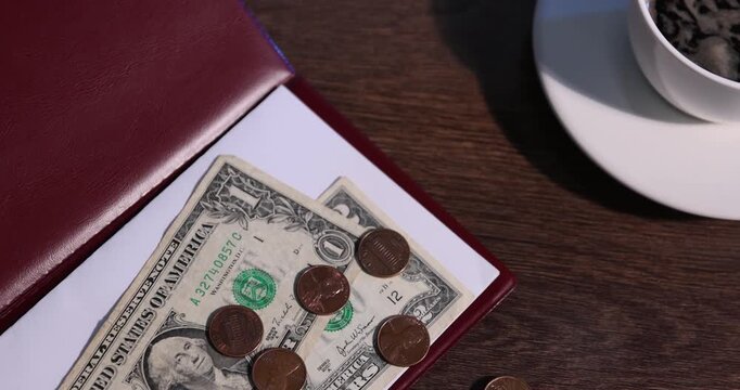 Tips and cup of coffee on wooden table, closeup