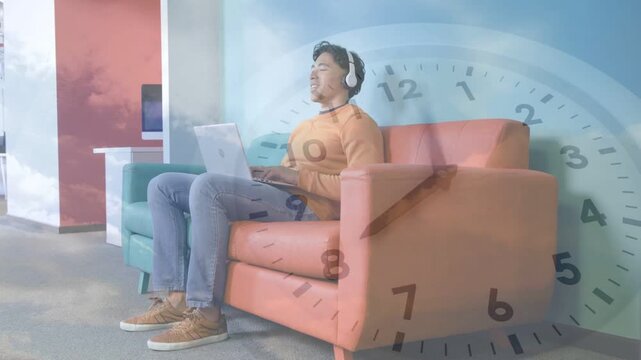 Man starting typing on laptop in lounge, causing clock cloud overlay fading while studying
