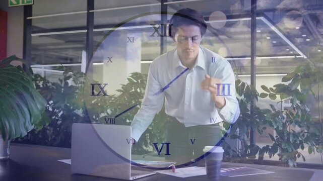 Businessman leaning over desk, glancing at laptop and clock overlay, moving cup to refocus