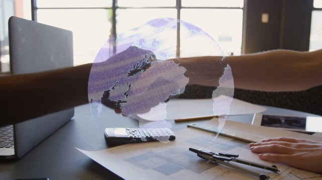 Fingertips meeting, hands reaching, clasping and shaking, globe rotating signaling deal over laptop