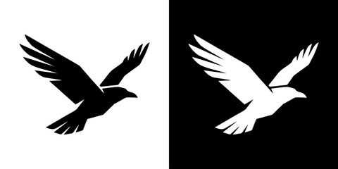 Fototapeta premium Birds depicted in contrasting black and white silhouettes fly side by side.