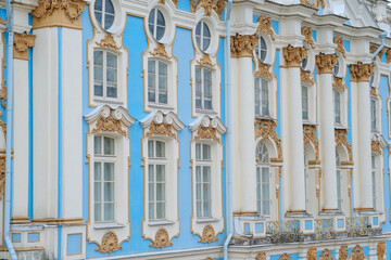 Fototapeta premium Close-up view of a historic building's facade showcasing blue and white colors, ornate windows, and classical architectural details
