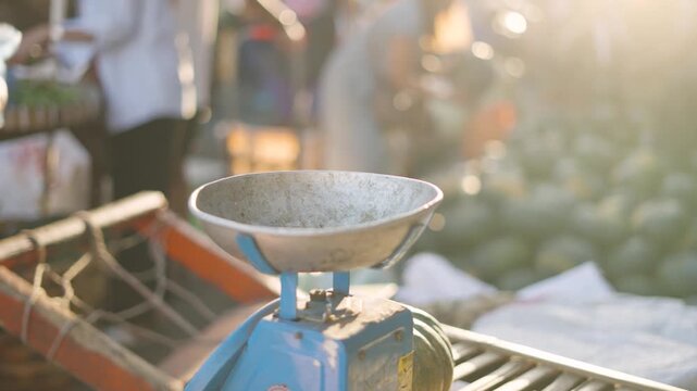 Street Vendor Weighing Fresh Vegetables in Small Plastic Bag During Golden Hour