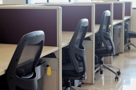 Empty Office Cubicles With Ergonomic Chairs In Modern Corporate Workspace With Clean Minimal Design