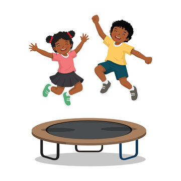 Two African children jumping on a trampoline having fun playing outdoor sport activity
