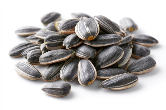 A pile of black and white striped sunflower seeds on a white background.