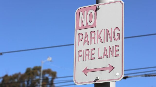Worn Out No Parking Fire Lane Sign With Blue Sky