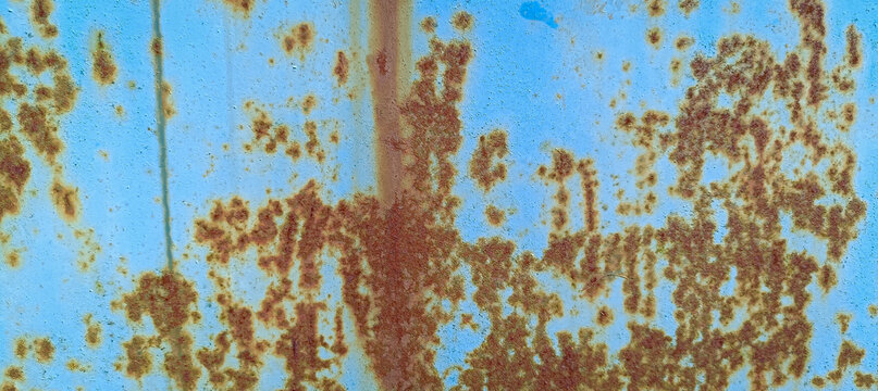 Close-up abstract view of a weathered, rusty metal surface with a distinct blue undertone, highlighting textures and imperfections
