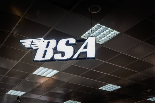 BELGRADE, SERBIA - MARCH 22, 2026: Illuminated BSA logo suspended from the ceiling in a dealership in Belgrade, BSA, or Birmingham Small Arms, is a British Motorcycle manufacturer.