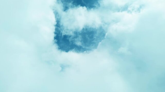 Cinematic aerial view above soft white clouds revealing patches of blue sky, creating a dreamy and peaceful atmosphere with perfect natural background footage