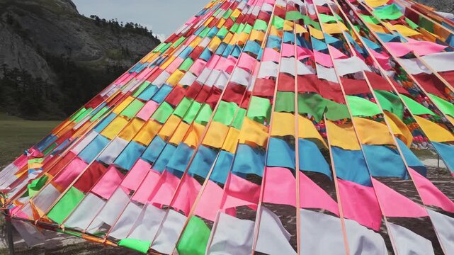 Geometric arrangement of multicolored prayer flags in Balagezong mountain landscape