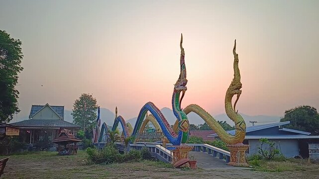 A Bridge Flanked by Colorful Naga Statues at Wat Phra That Mae Yen in Pai, Thailand.