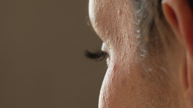 Eye, skin, human Close-up of a person's closed eye and facial skin texture in profile
