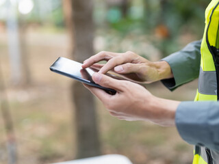 Asian engineer using tablet for digital monitoring and project management in engineering work. © Charlie's
