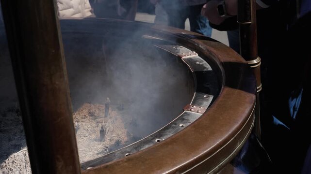 Multiple hands wafting incense smoke from burner at Senso-ji temple grounds Asakusa Tokyo Japan