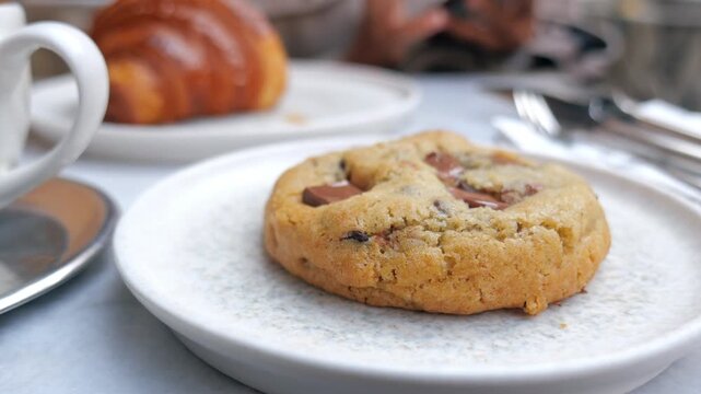 Enjoying a fresh cookie and croissant at a cafe