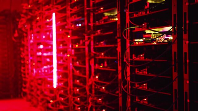 Abstract background featuring blinking lights on server racks inside a modern high performance data center facility during operation.
