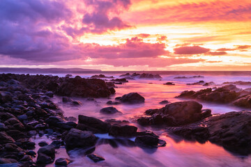 Fototapeta premium Colorful sunset over rocky coastline at Carrickalinga South Australia