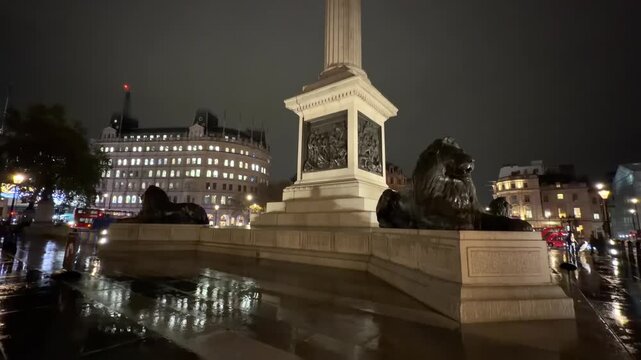 Fountain And Lion At Nelsons Column At Trafalgar Square During Night In London, United Kingdom.