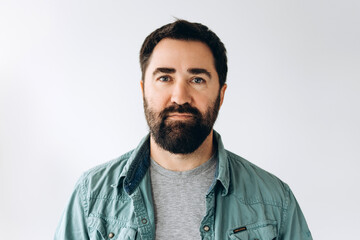 Obraz premium Serious bearded Latin man wearing stylish casual clothes confident and happy looking at camera