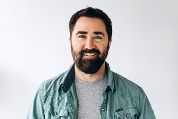 Fototapeta premium Smiling bearded Latin man wearing stylish casual clothes confident and happy looking at camera
