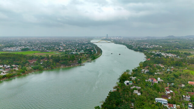 Hue City, Central Vietnam &ndash; 4K Aerial Drone View of Perfume River, Urban Skyline, Riverside Landscape, Bridges, Residential Areas and Scenic Cityscape near Thien Mu Pagoda
