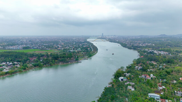 Hue City, Central Vietnam &ndash; 4K Aerial Drone View of Perfume River, Urban Skyline, Riverside Landscape, Bridges, Residential Areas and Scenic Cityscape near Thien Mu Pagoda