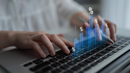 Obraz na płótnie Canvas Close-up of hands working on a laptop keyboard with digital graphs and percentages, illustrating concepts of financial growth and data analysis in a bright workspace. Cyphers