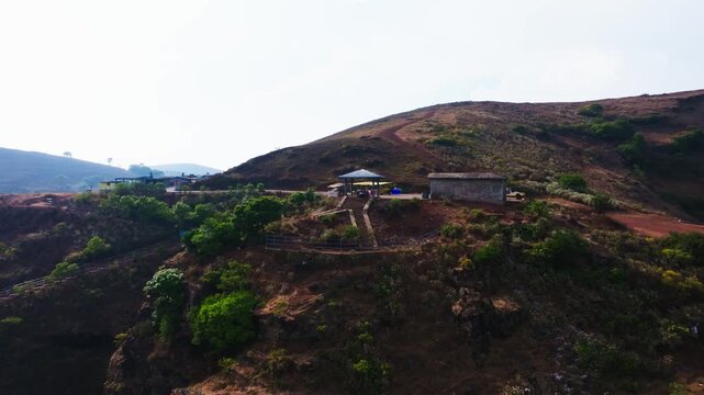 Manikyadhara view point with mountain peak, haze and sky at Baba Budangiri, Inam Dattathreya Peeta, Chikkamagaluru, karnataka, india. day time, push back shot, drone shot, 4k.