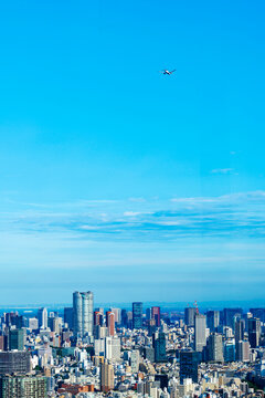 High-density corporate real estate and financial district under a clear sunset sky in Tokyo.