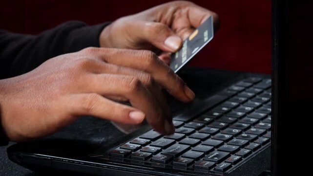 Credit Cards Theft. Hacker with Credit Cards on His Laptop Using Them For Unauthorized Shopping. Unauthorized Payments. Stolen Credit Cards Concept.