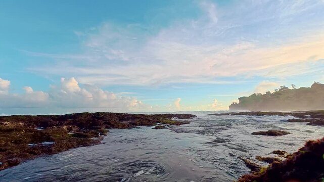 Tidal channel winding through rocky tropical beach