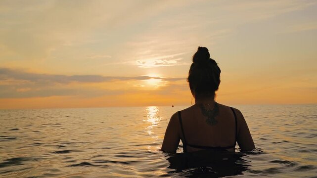Female lowering body into ocean with wearable device, digital twin health