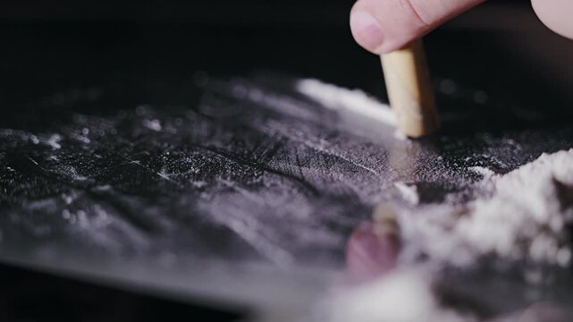 Symbolic depiction of drug use and social issue with powder arranged on surface