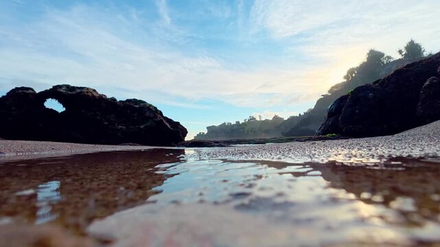 Low view of calm tidal water between cliffs